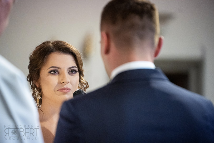 Pocałunek pary młodej na tle dekoracji